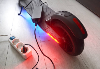 A black scooter with red light Description automatically generated